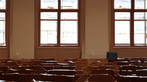 An empty lecture hall with wooden benches and a podium at the front