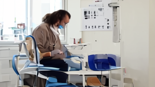 A phlebotomist prepares donation tubes beside a donor chair and appointment schedule.