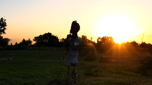 A family setting up a small telescope at dusk while keeping it pointed away from the low sun