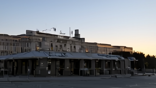 The Kennedy Center exterior with crews working near covered signage at dusk.