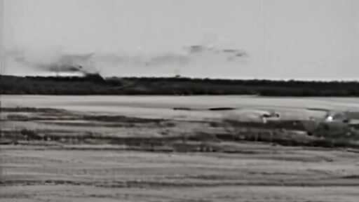 The X-59 flying above a desert range while sound instruments sit below