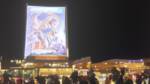 A multiplex lobby at night with a science-fiction film standee lit by marquee glow and an older crowd in the ticket line